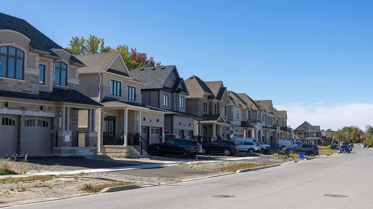 Suburban houses along Northglen Boulevard in Bowmanville, Durham Region, on a clear day; no people visible.