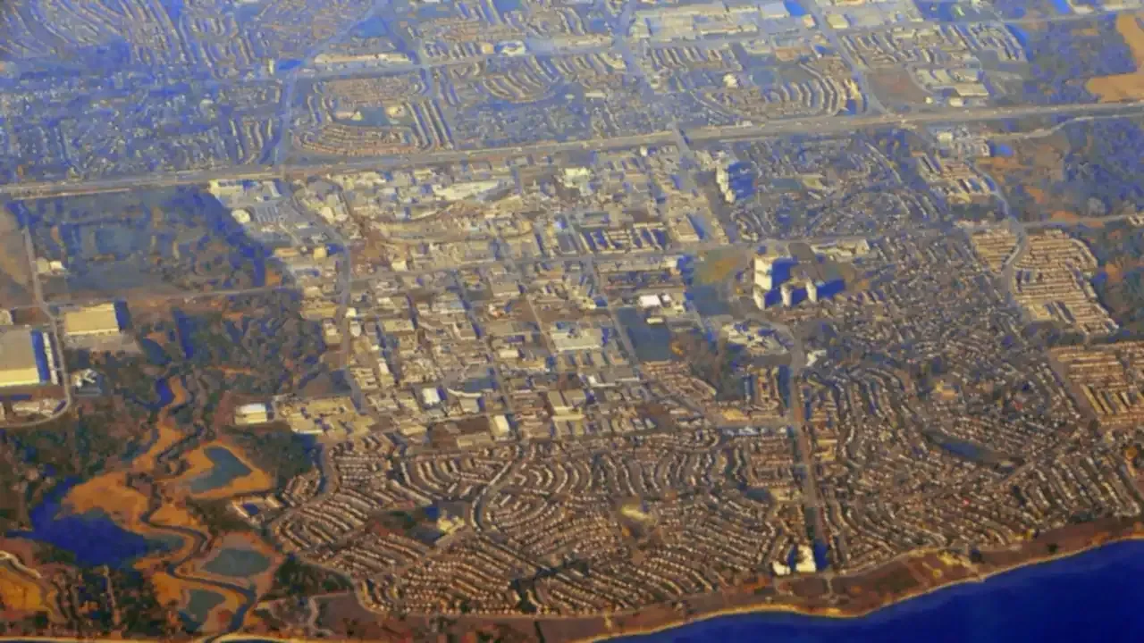 Aerial view of Ajax, Ontario, showing residential neighbourhoods, commercial areas and the Lake Ontario shoreline.