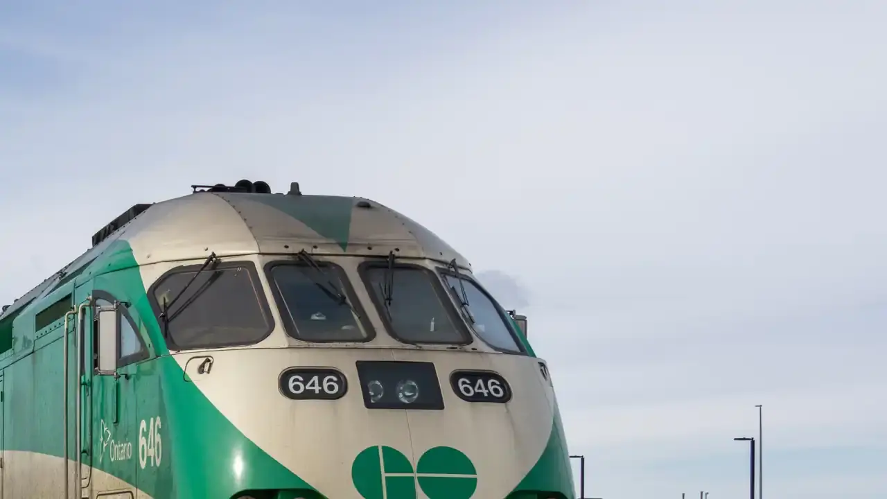 Front of a GO Transit locomotive at Oshawa GO Station under a pale sky. File photo from February 2026; the train shown is not one of the new trips.