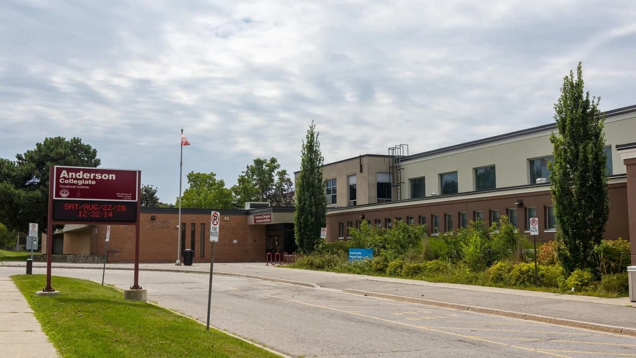 Exterior of Anderson Collegiate Vocational Institute, a Durham District School Board secondary school at 400 Anderson Street in Whitby, Ontario, photographed on an overcast summer day. No people visible.