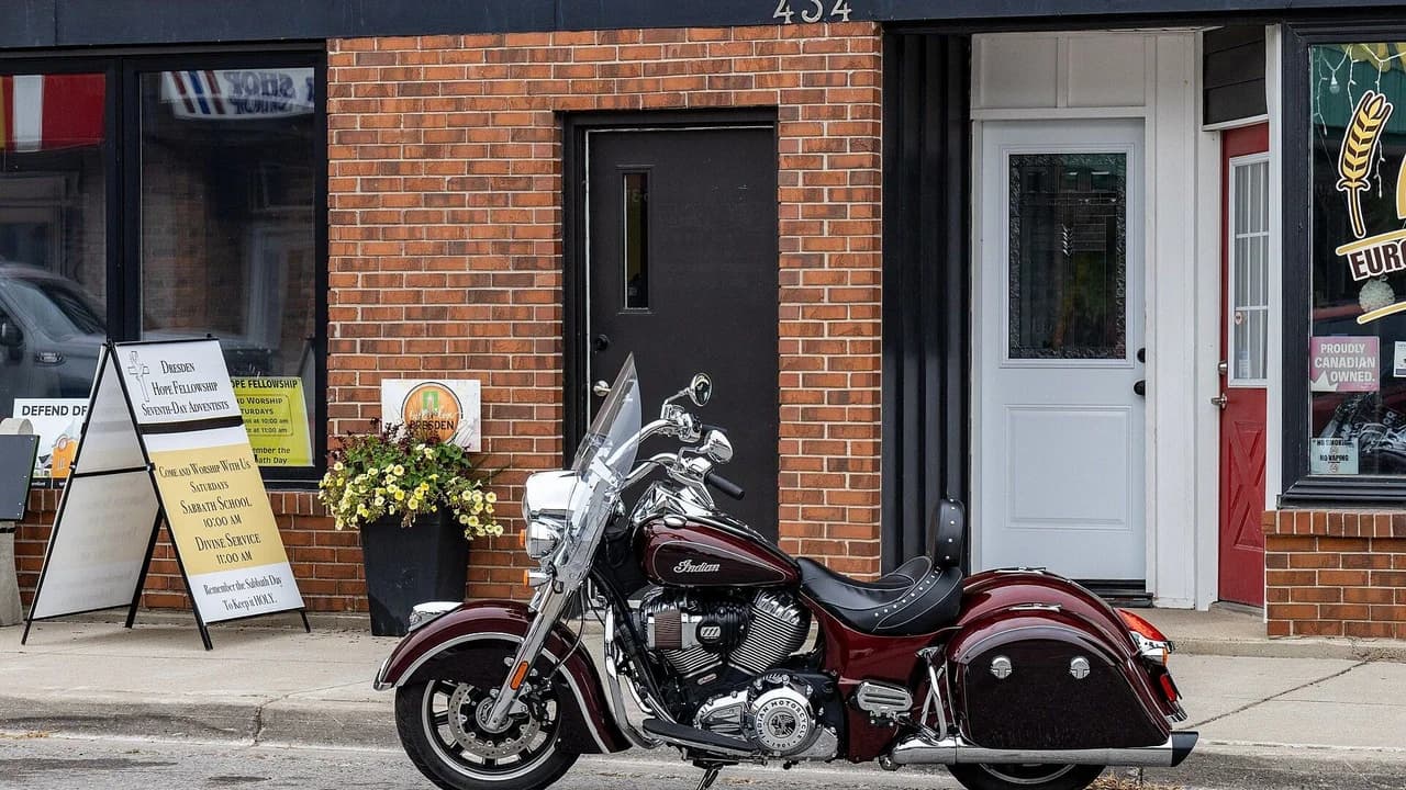 A maroon Indian Springfield motorcycle parked on a street in Dresden, Ontario; no people visible.