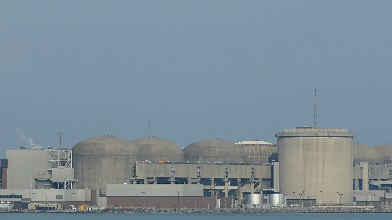 The Pickering Nuclear Generating Station's domed reactor buildings on the Lake Ontario shore; no people present
