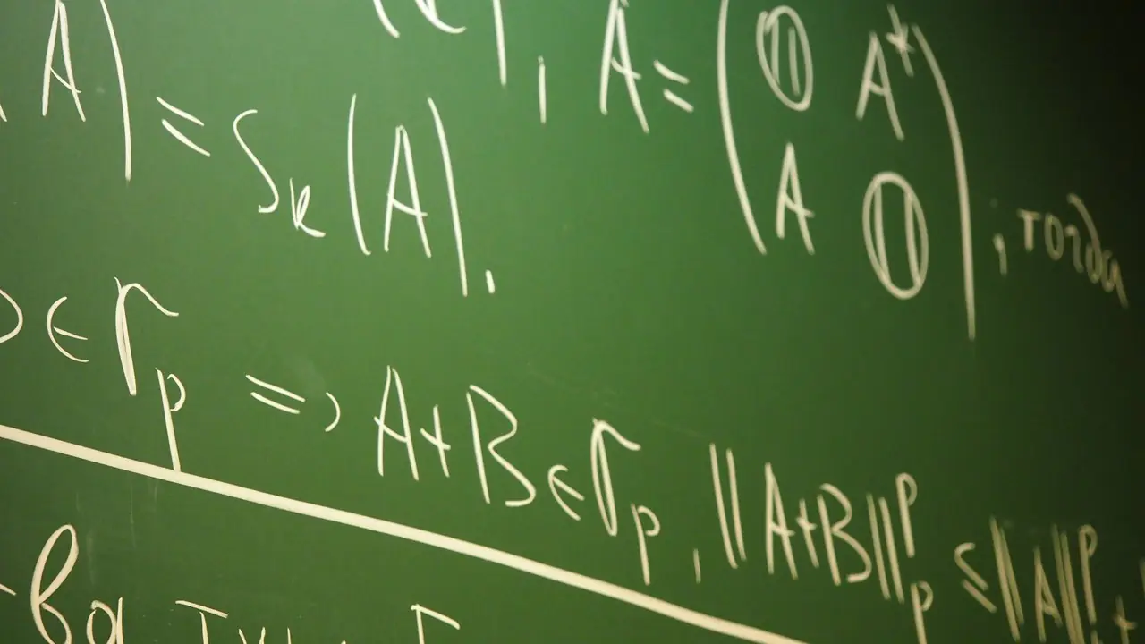A green chalkboard covered with handwritten mathematics equations