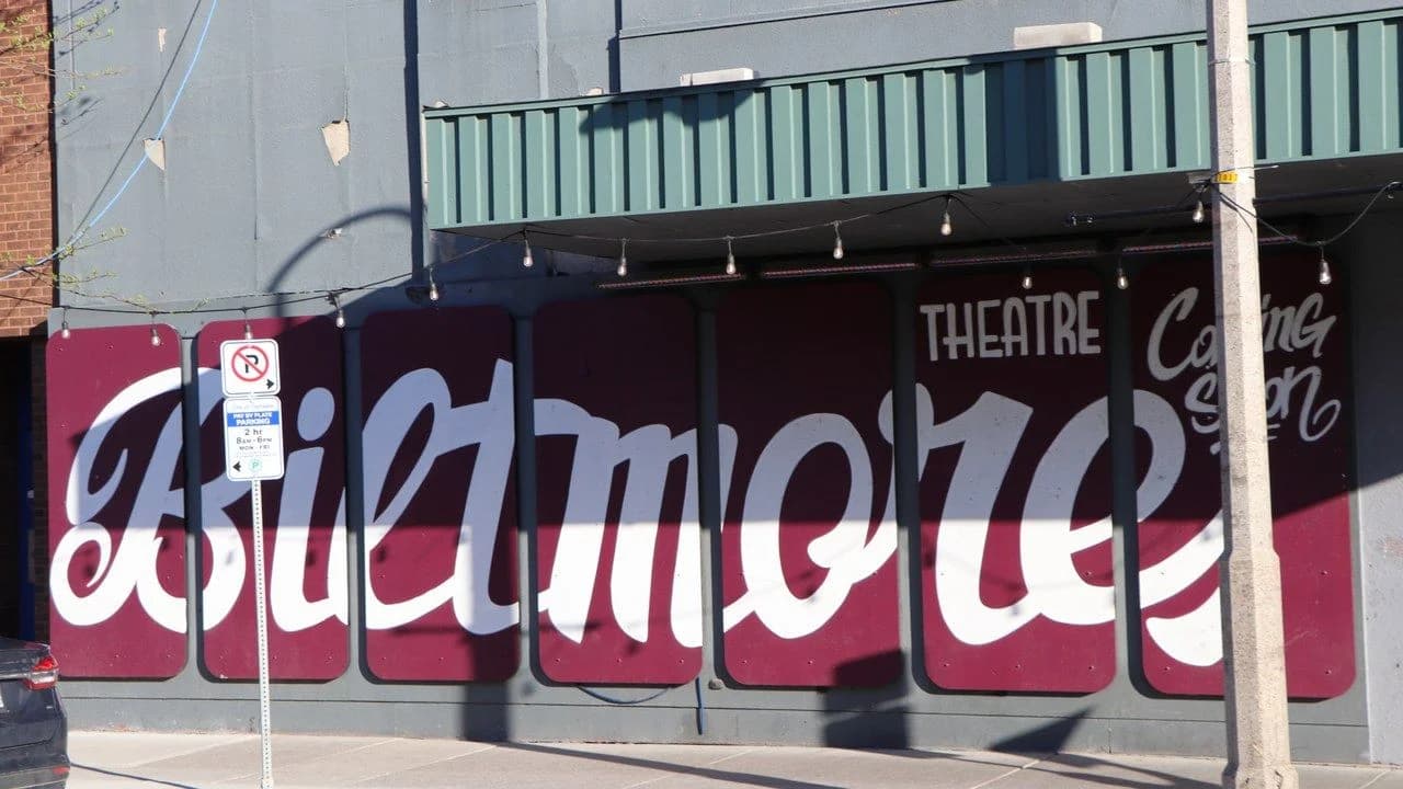 The Biltmore Theatre in Oshawa, Ontario — a historic downtown theatre with large Biltmore script lettering painted across burgundy marquee panels and a green awning above.