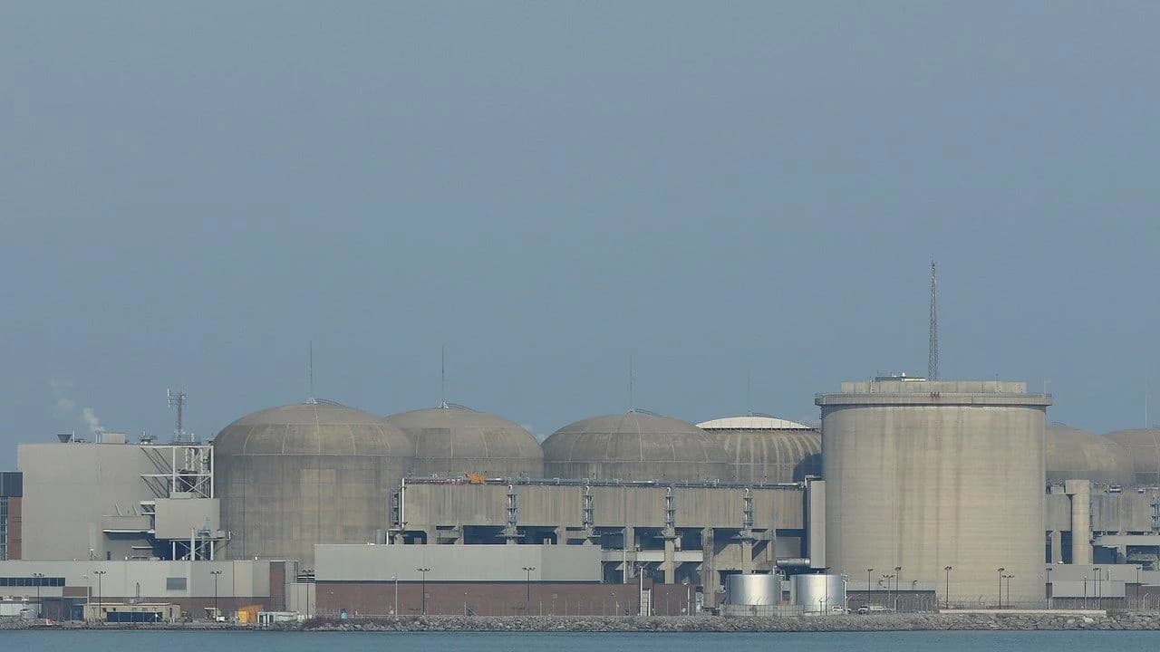 The Pickering Nuclear Generating Station's domed reactor buildings on the Lake Ontario shore; no people present