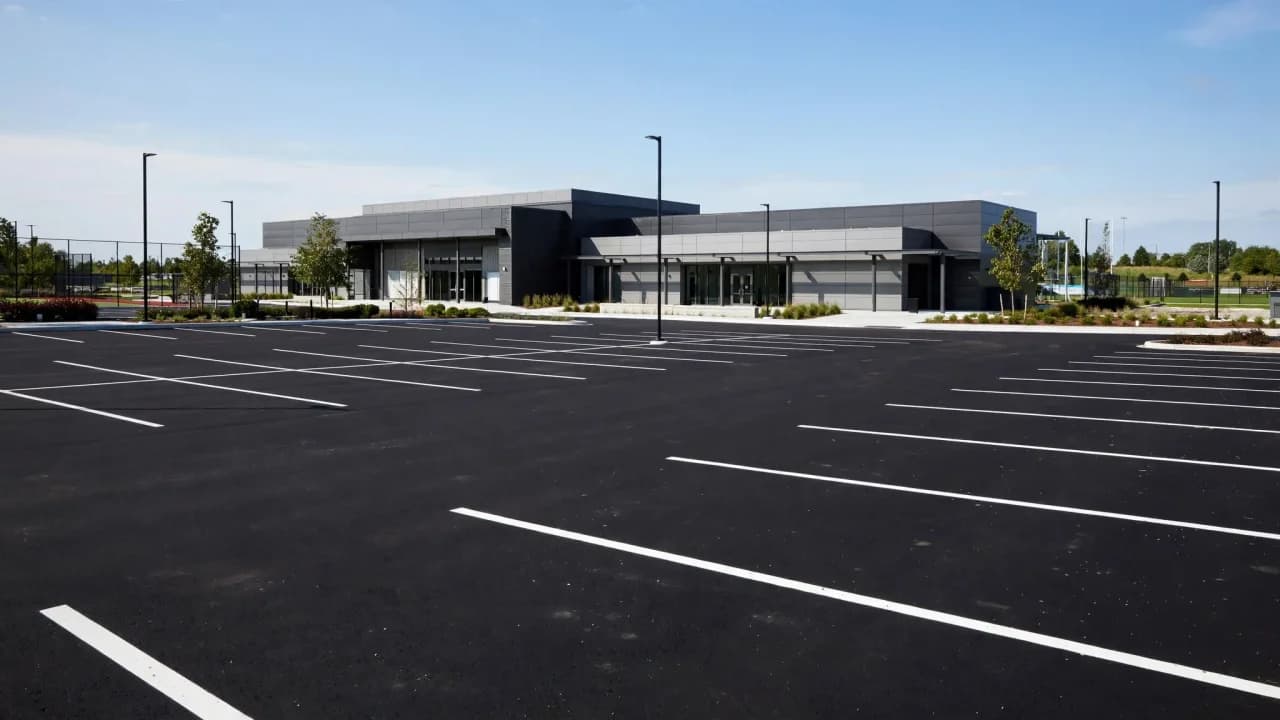 AI-generated illustration of a newly paved empty parking lot at a modern sports complex