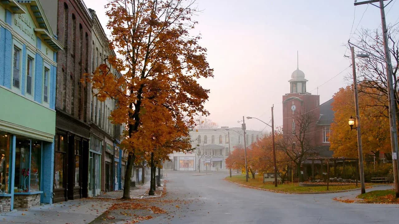 AI-generated illustration of a quiet Beaverton main street in the morning with heritage storefronts and autumn trees